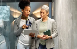 two executives comparing GyrusAim lms system to competitors